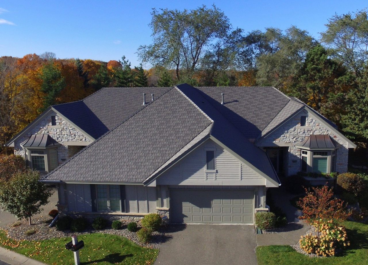 Euroshield Beaumont Shake recycled rubber roof on a large hip-roof home, aerial view
