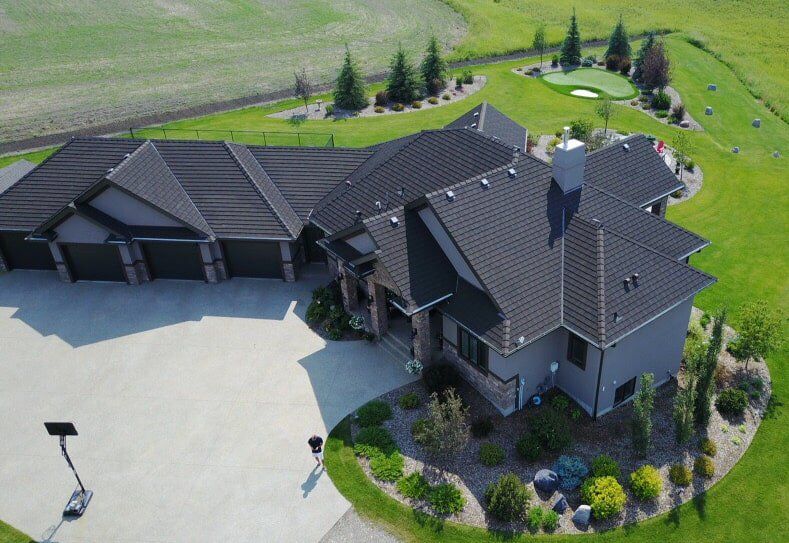 Euroshield Ranchlands Shake recycled rubber roof on an acreage home, aerial view