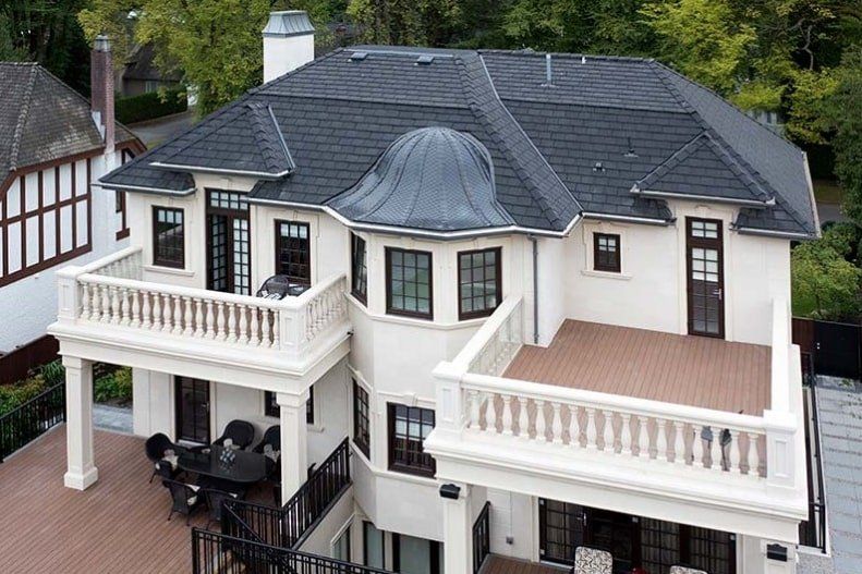 Euroshield Rundle Slate recycled rubber roof on a white home with balconies