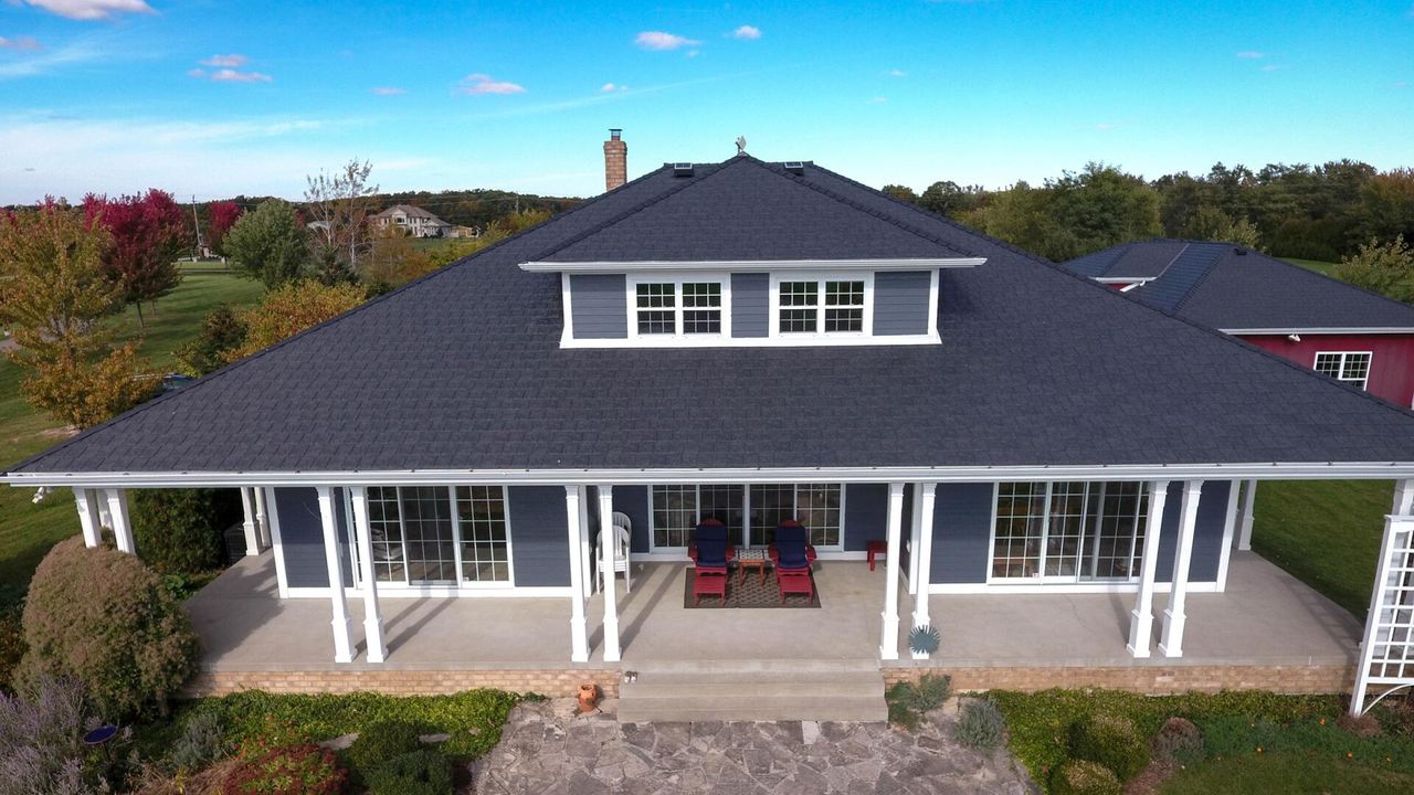 Euroshield Vermont Slate HP recycled rubber roof on a home with a wraparound porch