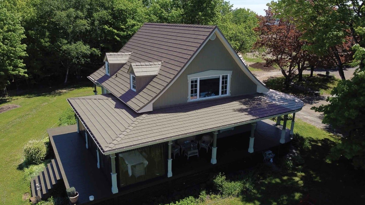 Vicwest True Nature Cedar Creek Shake steel roof on a farmhouse with a wraparound porch