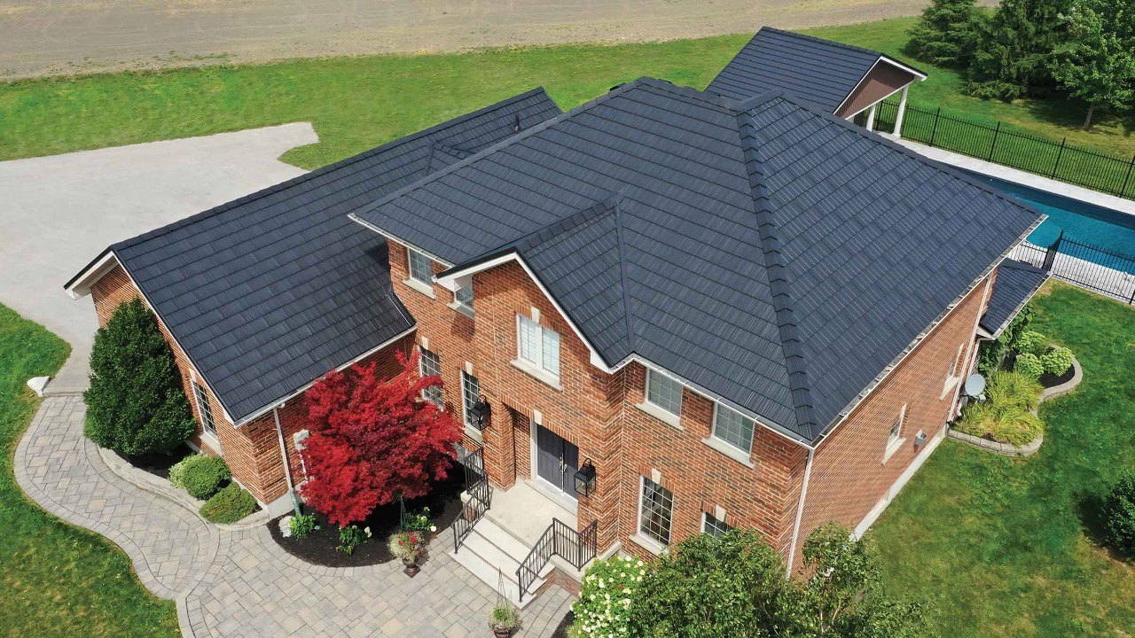 Vicwest True Nature Cedar Creek Shake steel roof on a brick home, aerial view